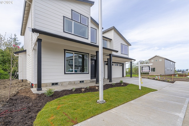 view of front facade with a front yard and a garage