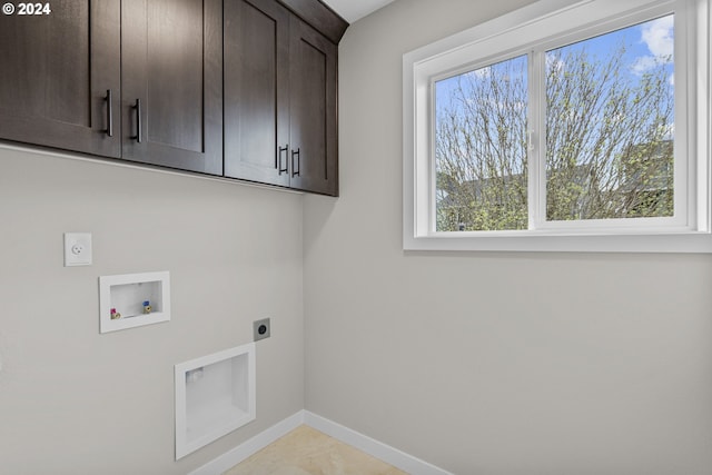 clothes washing area featuring hookup for a washing machine, hookup for an electric dryer, cabinets, and light tile floors