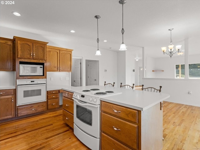 12405 SW Poppy Dr, Gaston, OR 97119 - kitchen with white appliances, light wood finished floors, light countertops, pendant lighting, and recessed lighting