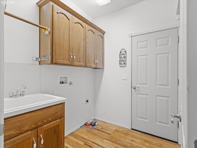 12405 SW Poppy Dr, Gaston, OR 97119 - laundry room with hookup for an electric dryer, hookup for a washing machine, cabinet space, light wood-style floors, and baseboards
