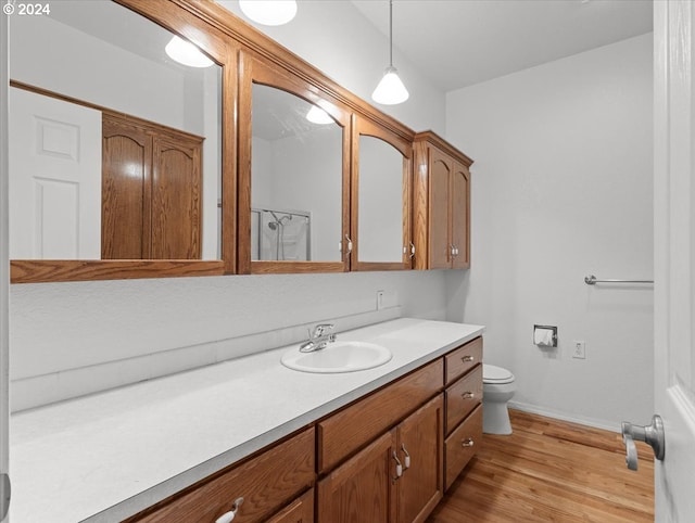 12405 SW Poppy Dr, Gaston, OR 97119 - bathroom with vanity, toilet, wood finished floors, and baseboards