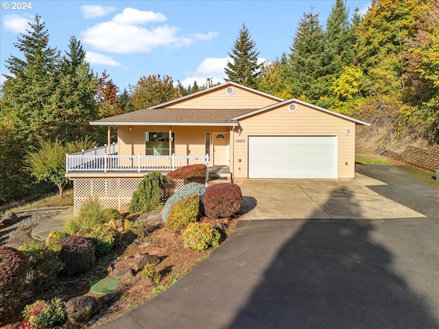 ranch-style home with a porch and a garage