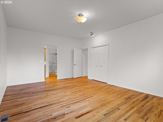 12405 SW Poppy Dr, Gaston, OR 97119 - unfurnished bedroom with light wood finished floors, a closet, baseboards, and connected bathroom