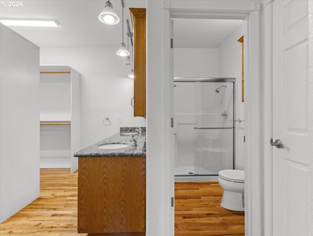 12405 SW Poppy Dr, Gaston, OR 97119 - bathroom featuring a stall shower, wood finished floors, toilet, and double vanity
