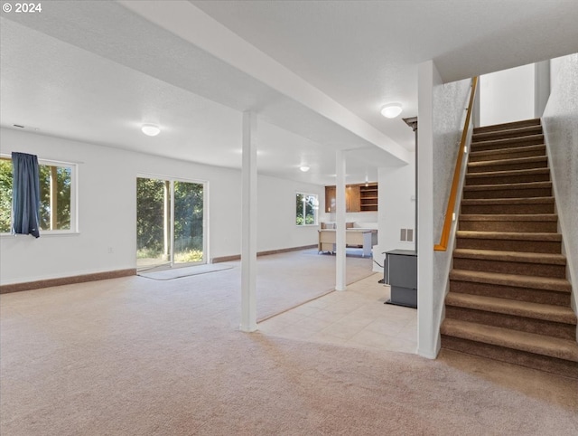 12405 SW Poppy Dr, Gaston, OR 97119 - below grade area featuring light colored carpet, stairs, baseboards, and light tile patterned floors