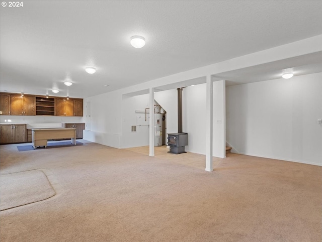 12405 SW Poppy Dr, Gaston, OR 97119 - unfurnished living room featuring light colored carpet, stairway, water heater, and a wood stove