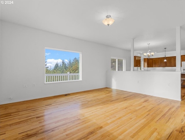 12405 SW Poppy Dr, Gaston, OR 97119 - empty room featuring a chandelier and light wood-style floors