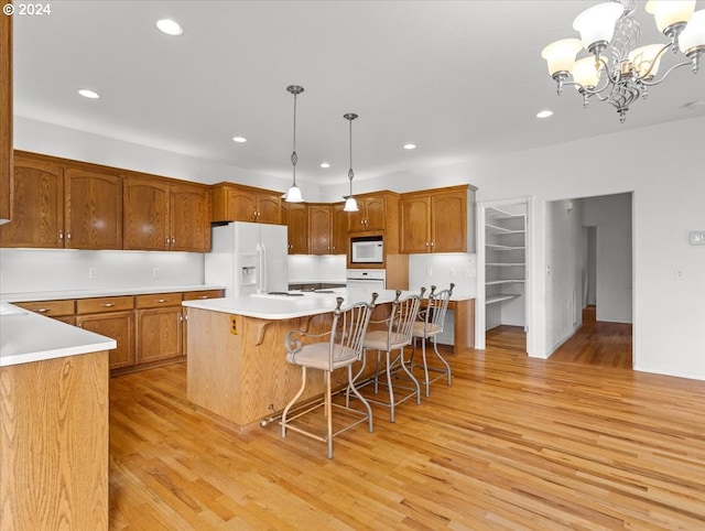 12405 SW Poppy Dr, Gaston, OR 97119 - kitchen featuring white appliances, light wood-style flooring, recessed lighting, a chandelier, and light countertops