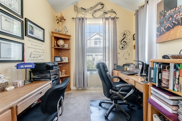 carpeted office space with a healthy amount of sunlight and vaulted ceiling