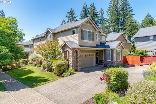 craftsman-style house with a garage and a front lawn