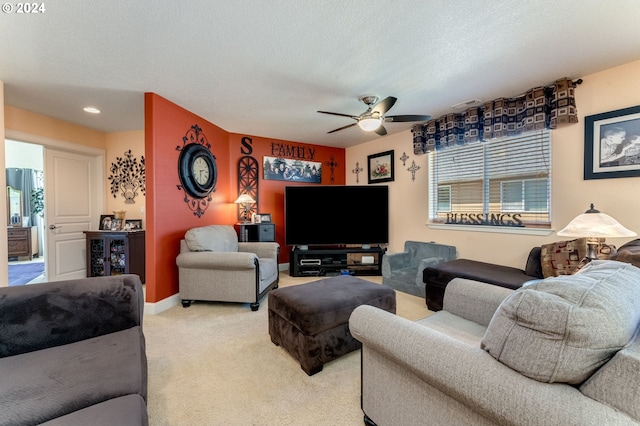 carpeted living room featuring ceiling fan, a textured ceiling, and a wealth of natural light