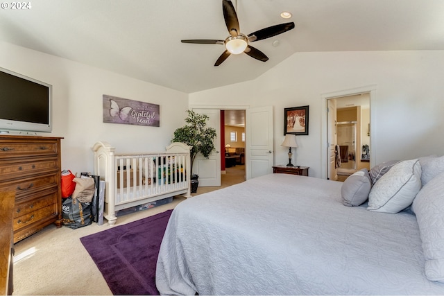 carpeted bedroom with ceiling fan, lofted ceiling, and connected bathroom