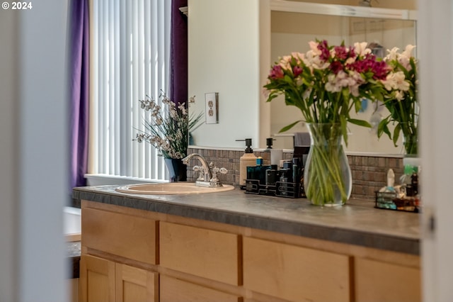 bathroom featuring sink and tasteful backsplash