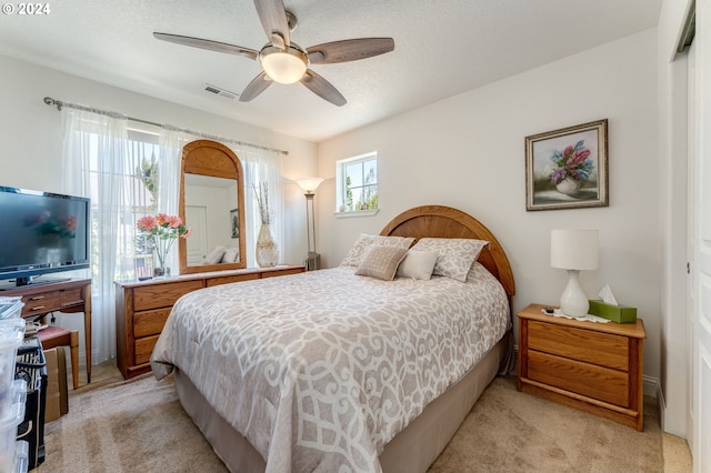 bedroom with light colored carpet and ceiling fan