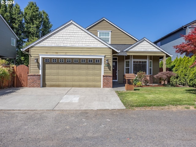 craftsman house with a front lawn and a garage