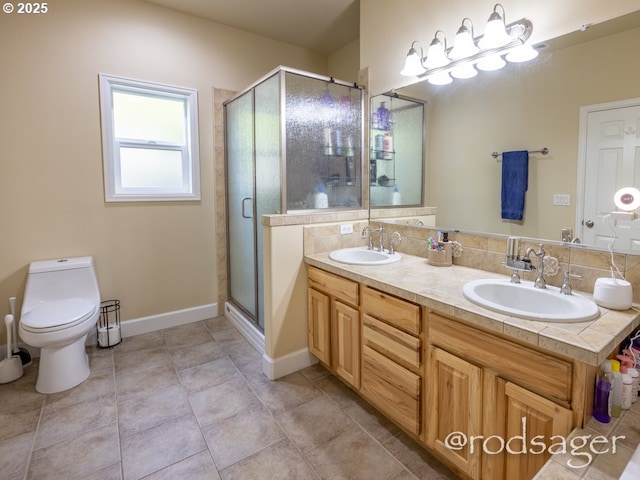 bathroom with decorative backsplash, a shower with door, vanity, and toilet