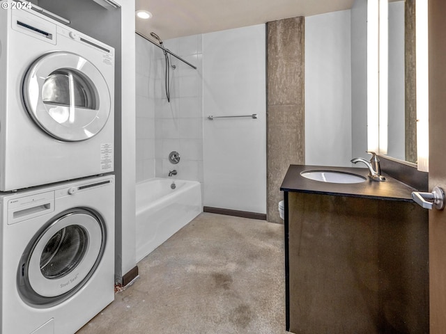 full bath featuring  shower combination, concrete floors, stacked washer / dryer, and vanity