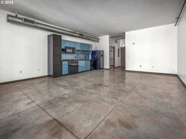 interior space featuring visible vents, baseboards, and freestanding refrigerator