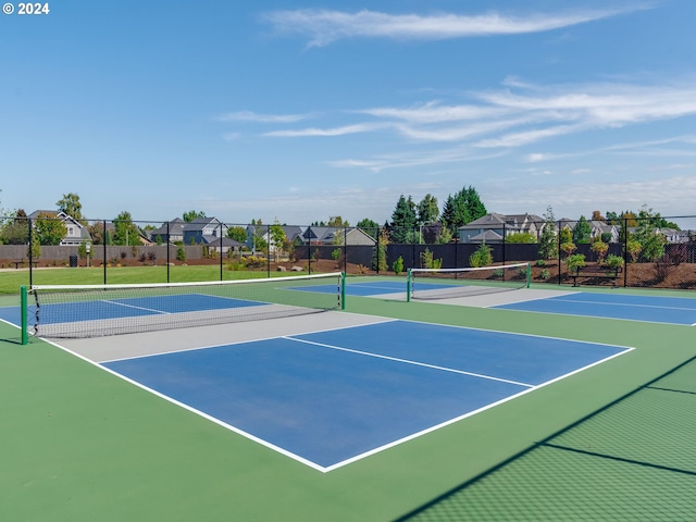 view of tennis court featuring basketball hoop