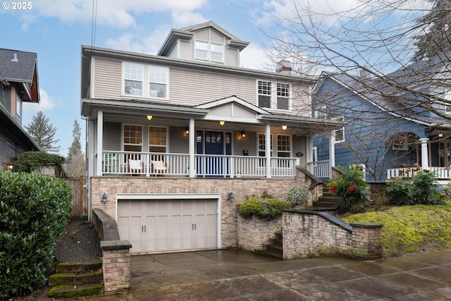 view of front of property featuring a garage and a porch