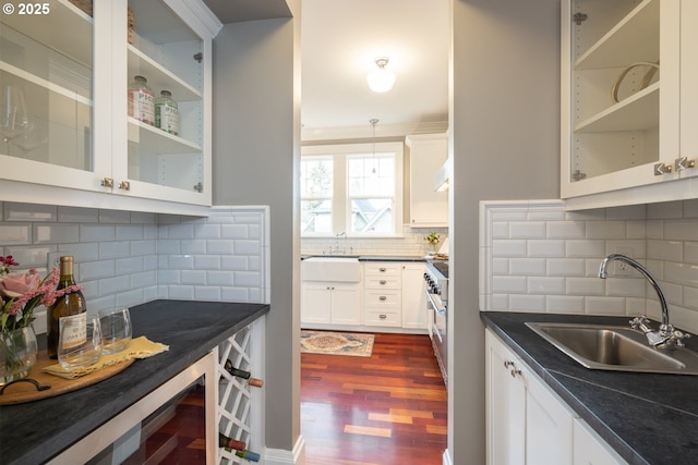 kitchen with white cabinetry, sink, pendant lighting, and dark hardwood / wood-style flooring