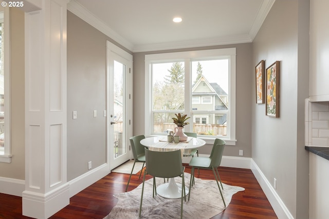 dining area featuring crown molding and dark hardwood / wood-style flooring