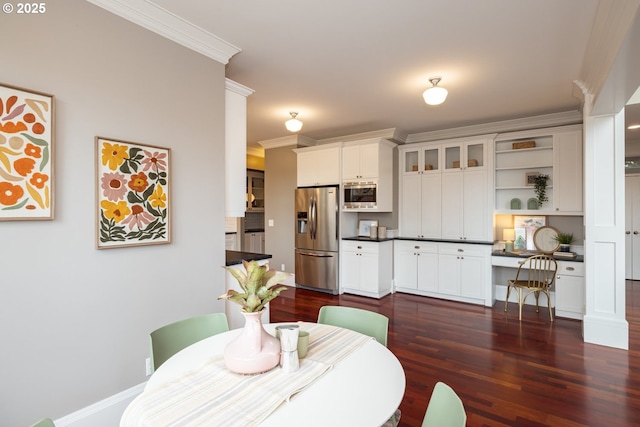 dining area featuring crown molding, dark hardwood / wood-style floors, and built in desk