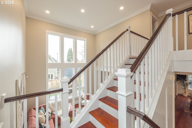 staircase with hardwood / wood-style flooring and crown molding