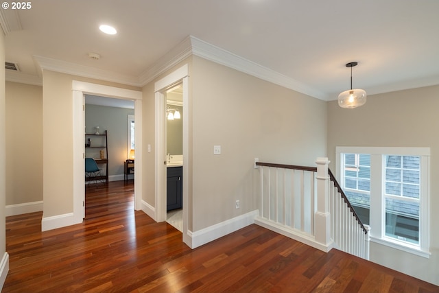 hallway with crown molding, dark hardwood / wood-style flooring, and sink