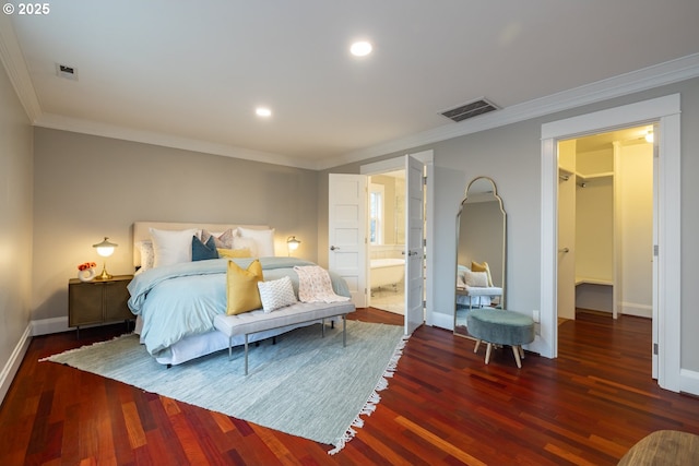 bedroom with ornamental molding, dark hardwood / wood-style floors, and ensuite bathroom