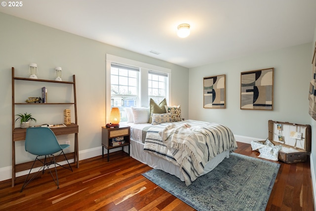 bedroom with dark hardwood / wood-style floors