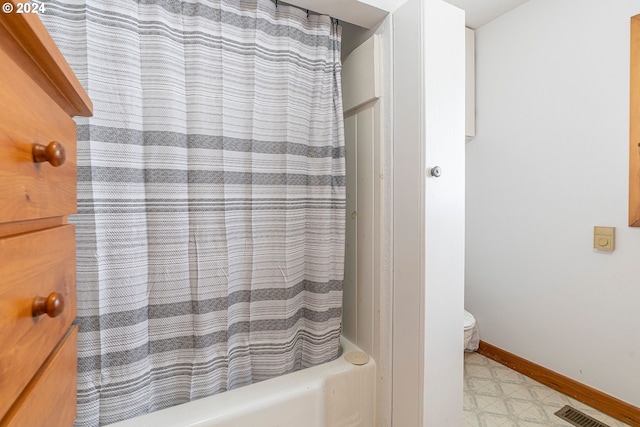 bathroom featuring shower / bathtub combination with curtain and tile patterned flooring