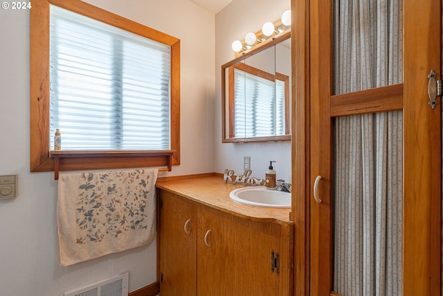 bathroom featuring vanity and a wealth of natural light