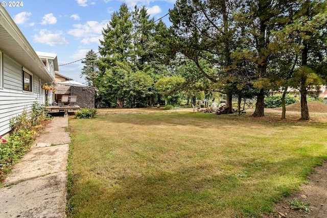 view of yard with a wooden deck