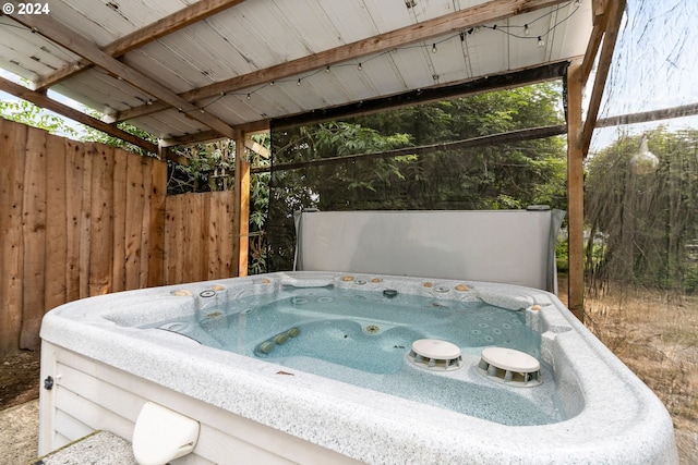 view of swimming pool featuring a hot tub