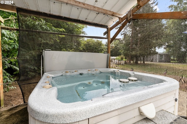 view of pool with a hot tub