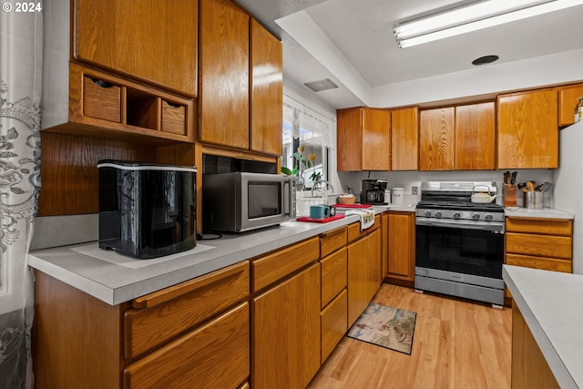 kitchen featuring light hardwood / wood-style flooring, sink, and stainless steel appliances