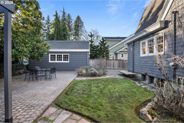 view of yard featuring an outdoor structure and a patio area