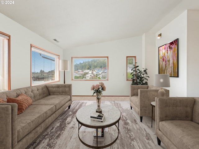 living area featuring vaulted ceiling and baseboards