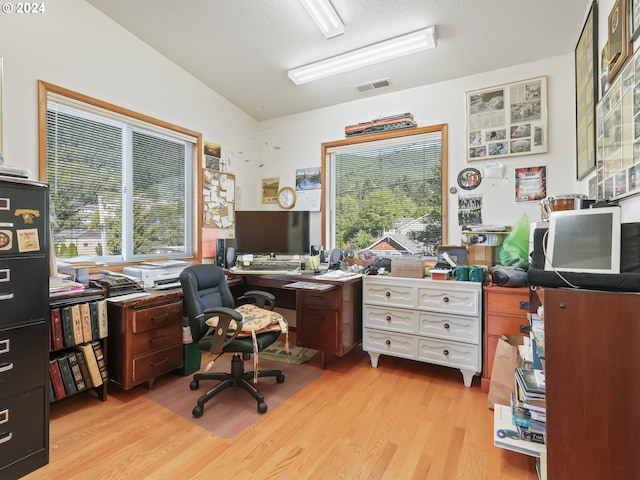 office featuring a textured ceiling and light hardwood / wood-style floors