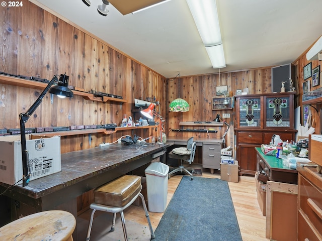 office area featuring light wood-type flooring and wood walls