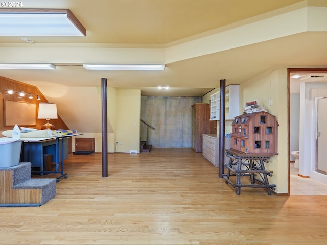 finished basement featuring wood finished floors and stairway