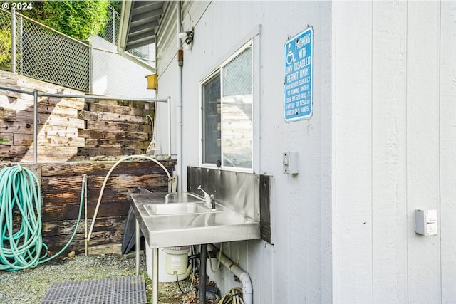 exterior space with wooden walls and sink