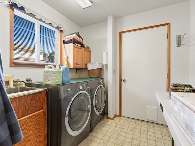 clothes washing area featuring cabinets and independent washer and dryer