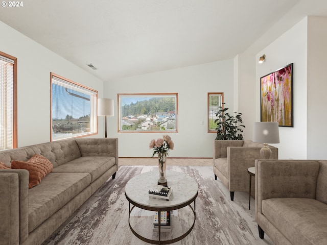 living room featuring lofted ceiling and light hardwood / wood-style floors