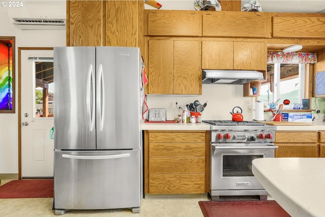 kitchen featuring ventilation hood, stainless steel appliances, and plenty of natural light