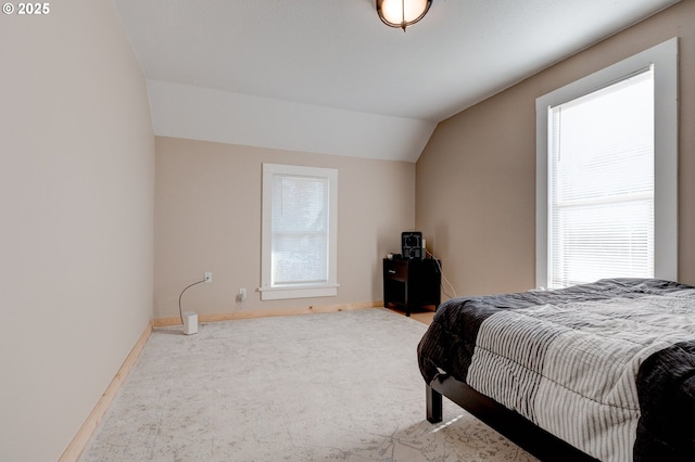 carpeted bedroom with multiple windows and vaulted ceiling