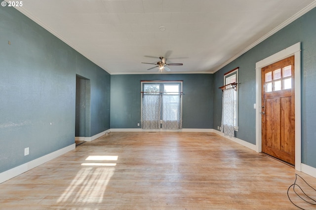 empty room featuring crown molding, light hardwood / wood-style flooring, and ceiling fan