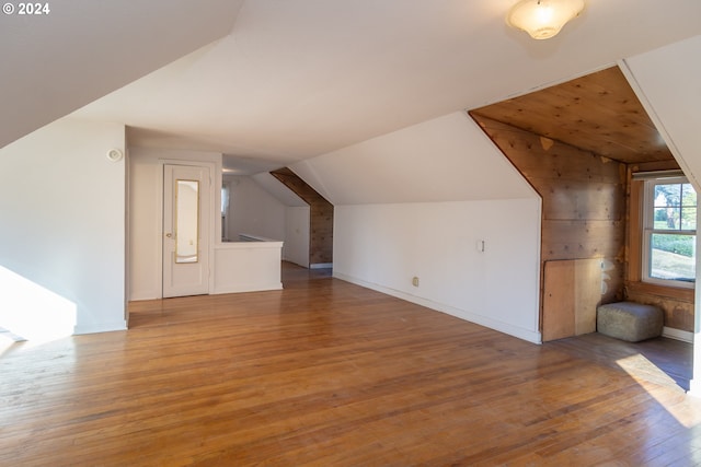 additional living space featuring hardwood / wood-style floors and vaulted ceiling