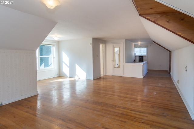 bonus room featuring lofted ceiling, hardwood / wood-style flooring, and plenty of natural light